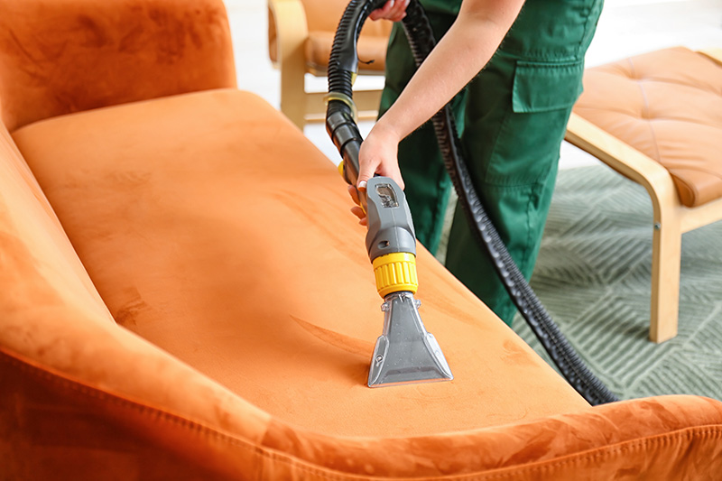 dry-cleaner-s-employee-removing-dirt-from-sofa-house-1